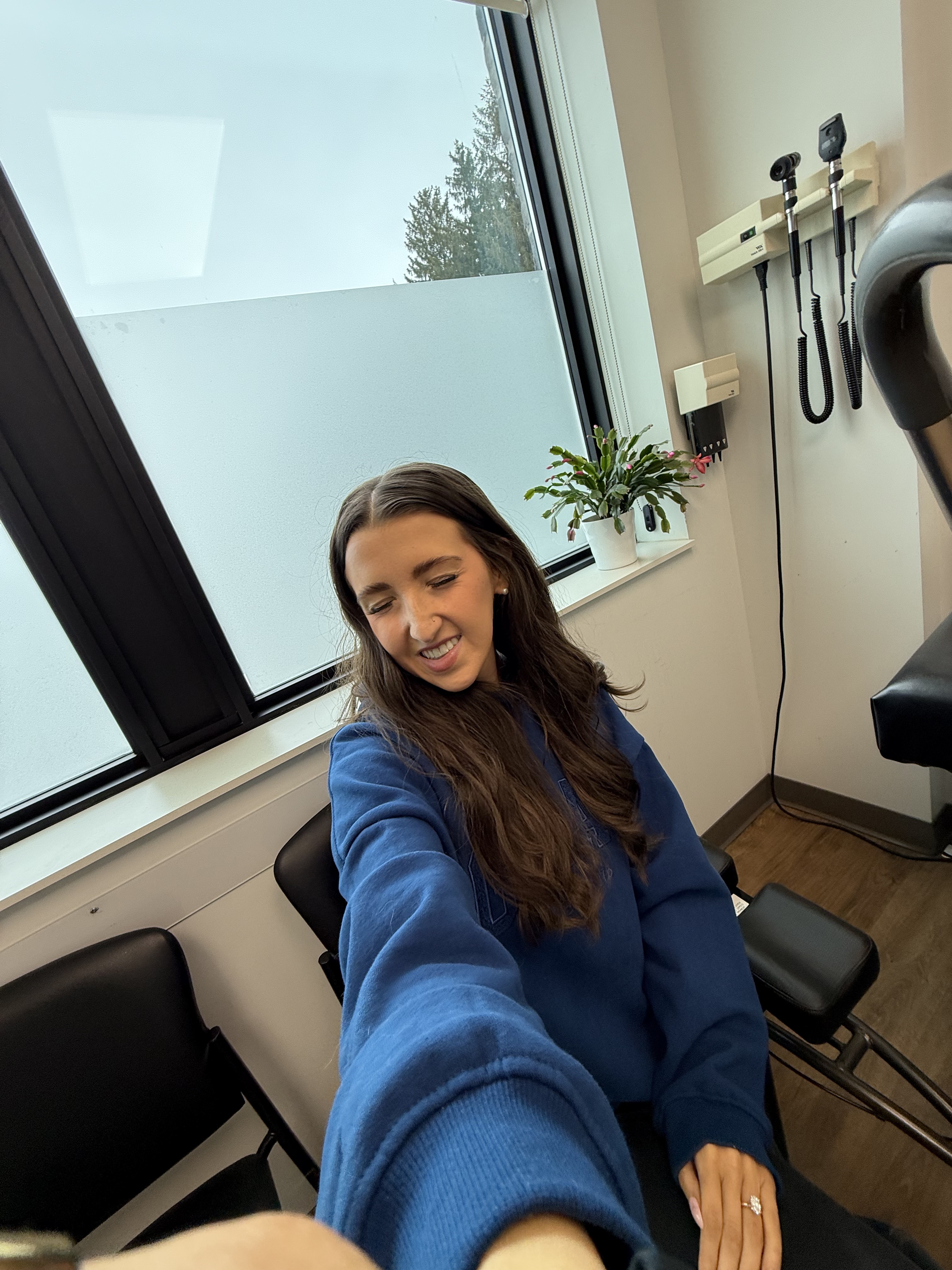Kale Vine and Nick in a medical exam room, both wearing masks, knee scooter visible beside them