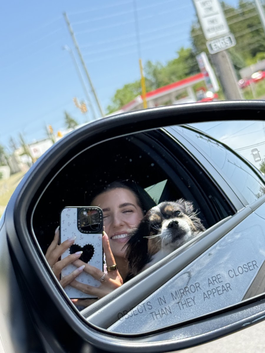 Car side mirror selfie with Mila the dog